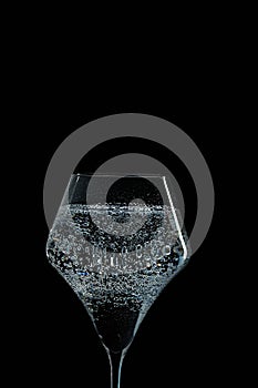 Mineral water is poured into a glass.