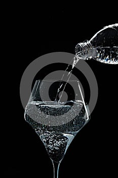 Mineral water is poured into a glass.