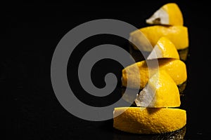 Mineral water with sliced lemon, ice cubes and water splash on black background horizontal view