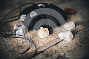 minerals and raw stones in a bag on a wooden table