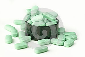 Minerals supplement tablets on a bottle cap