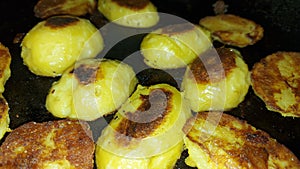 Minerals and vitamins. Roasted potatoes close-up. Halves of potatoes in a pan.