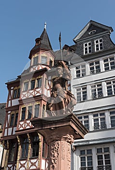 The minervabrunnen in front of the half-timbered houses on Roemerberg in Frankfurt, Germany photo