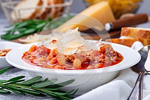 Minestrone soup with cavatappi pasta, beans and vegetables, served with crispy bread, horizontal