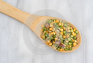 Minestrone soup mix in a spoon on marble cutting board