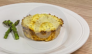 Mini asparagus pie on white dish
