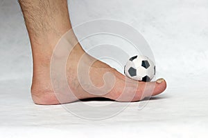 Mini ball of football on the foot with white background.