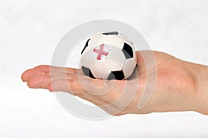Mini ball of football in hand and one black point is England flag