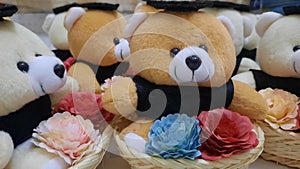 Mini bear doll with flower in a webbing basket