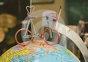 Mini Bicycle on Model of The Globe of Earth