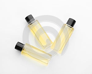 Mini bottles with cosmetic products on white, top view. Hotel amenities