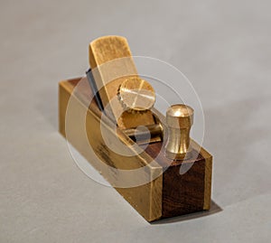 Mini brass hand plane for violin makers, isolated closeup