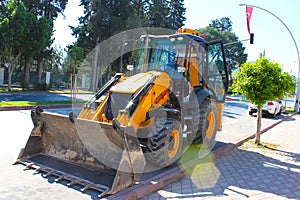Mini bulldozer or excavation or loader on road.