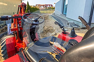 Mini bulldozer parked at the ouse for ground work