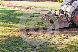 Mini Bulldozer Removing Grass From Yard Preparing For Pool