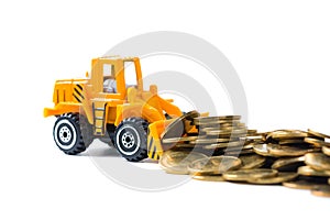 Mini bulldozer truck loading stack coin with pile of gold coin,