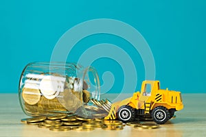 Mini bulldozer truck loading stack coin with pile of gold coin t