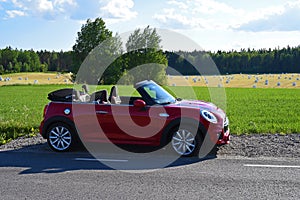 Mini cabrio during summertime parked beside a countryroad photo
