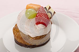 Mini cake topped with creamy mousse and fruit