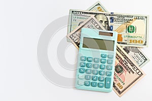 Mini calculator and US 100 and 50 dollars on white background. American cash, savings, taxes, benefit, income, money, finance