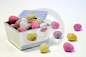 Mini candy chocolate eggs in a polished silver box