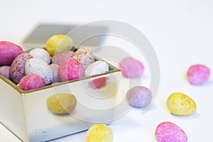 Mini candy chocolate eggs in a polished silver box