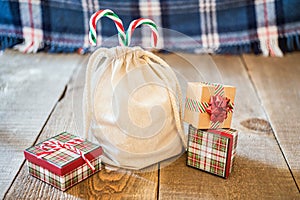 Mini canvas gift sack with candy canes sticking out the top, gif