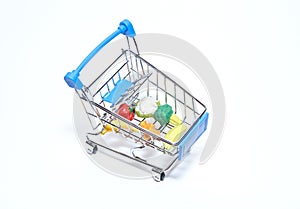 Mini cart from a supermarket with products on a white background. Top view