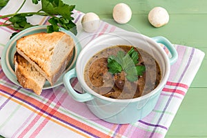 Mini casserole of mushroom soup with parsley and and grilled toast