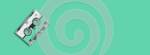 Mini cassette tape on colored background.