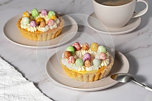Mini cheesecakes with candy eggs and whipped cream