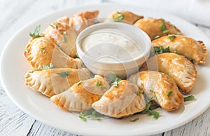 Mini chicken pies with creamy garlic sauce