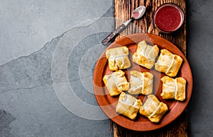 Mini chilean empanadas on clay plate with typical chilean drink vino con harina - red wine with toasted flour