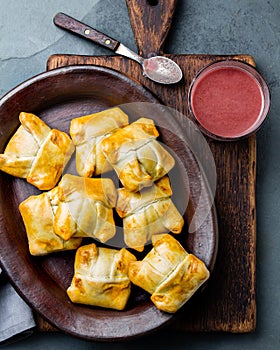 Mini chilean empanadas on clay plate with typical chilean drink vino con harina - red wine with toasted flour photo