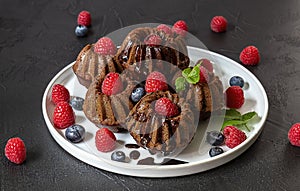 Mini chocolate cakes with chocolate and fresh berries