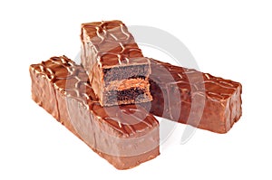 Mini chocolate cakes covered with fudge sauce, white background