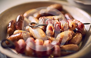 Mini Christmas sausages in a bowl with skewer