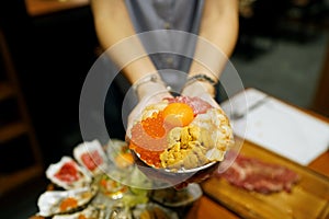 Mini donburi bowl - Japanese rice bowl topped with fresh tuna, sea urchin roe, salmon roe, scallop, sweet shrimp and topping egg