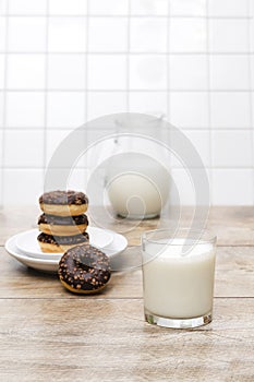 Mini donuts with chocolate glaze served with glass of milk.tasty sweet creamy doughnuts dessert food
