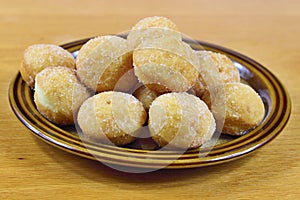 Mini doughnuts on a brown plate