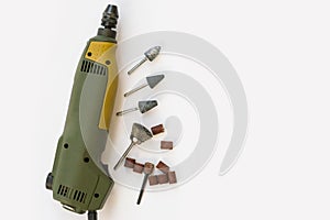 Mini drill with different nozzles on a white background.