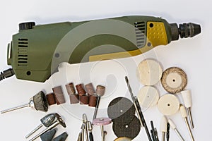 Mini drill with different nozzles on a white background.