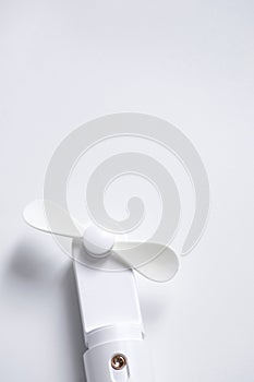 Mini electric fan with handle isolated on white background