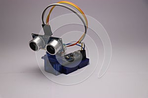 Mini electronic project using arduino,ultrasonic sensor and micro servo in white background photo