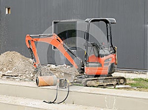 Mini excavator with construction equipment at work for replacement the cables or pipelines underground. No people