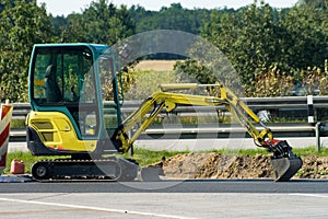 Mini excavator on motorway