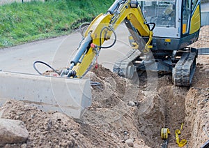 Mini excavator for road works for internet and power supply