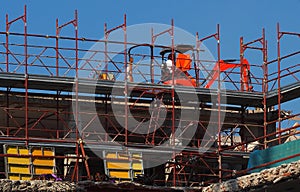 Mini excavator at work in the last floor of a building under refurbishment in a redevelopment area photo
