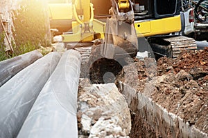 A mini excavator is working on a construction site