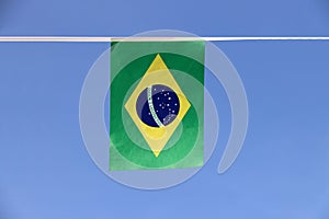 Mini fabric rail flag of Brazil, a blue disc depicting a starry sky with the national motto Order and Progress.